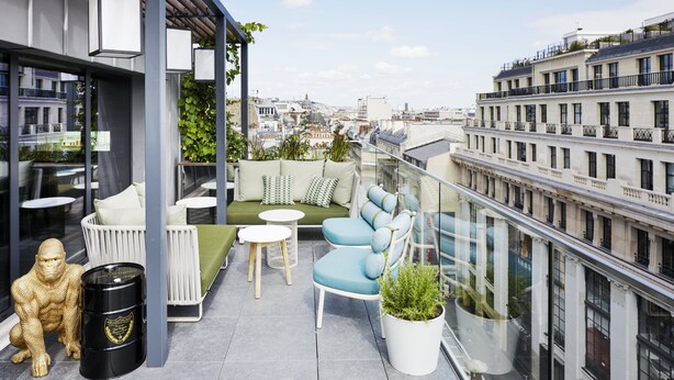 A modern rooftop terrace with seating, a small table, and a decorative sculpture. - citizenM Paris Champs-Élysées (Paris)