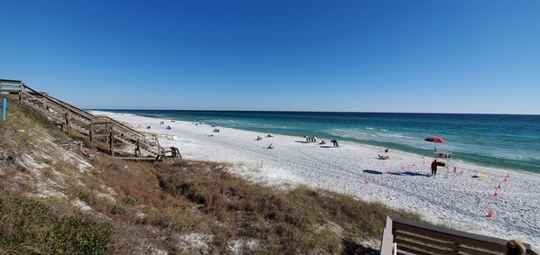 Guests can enjoy access to the beach via the stairs, with a lifeguard stand nearby for added safety.