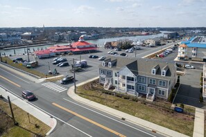 A coastal town with a marina, a red-roofed building, and a parking lot.