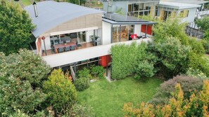 Enjoy al fresco dining in the serene surroundings of this house, surrounded by lush greenery and a well-maintained lawn.
