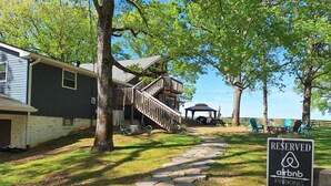 A pathway leading to a house with a deck and a gazebo. A sign indicates reserved parking for Airbnb. - Escape to the Country Penthouse (Dickson)
