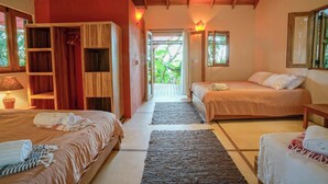 A room with two beds, a wardrobe, and a view of greenery outside. - Casa Blanca | Free Breakfast + Housekeeping | Pool (Cobano)