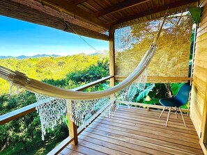 A hammock on a wooden deck with a view of green hills. - 3BR Ocean View Villa w/ Pool + Included Breakfast (Cobano)