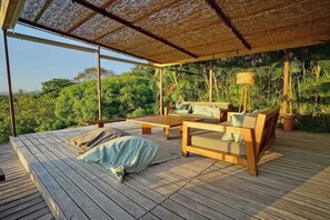 A wooden deck with a thatched roof, a sofa, and a table. - 3BR Ocean View Villa w/ Pool + Included Breakfast (Cobano)