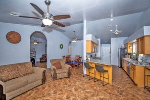Relax in this stylish living area with a sofa, armchair, and dining table.