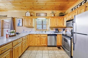 Enjoy cooking in this well-equipped kitchen with a dishwasher, microwave oven, and sink.