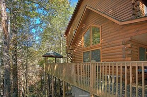 Enjoy a peaceful retreat with a balcony overlooking the surrounding forest.