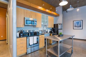 Enjoy cooking in this well-equipped kitchen with a microwave, oven, and island.