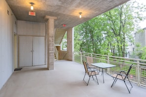 Enjoy a peaceful outdoor space with a table and chairs overlooking lush surroundings.