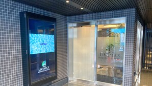 Ein Hotel Eingangsbereich mit gefliestem Boden und einer großen Werbung für Live Max Hotels & Resorts.