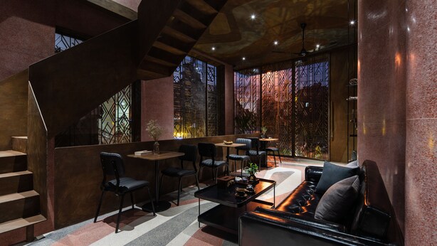 A modern interior with a staircase, seating area, and a bar. - The Note Dalat - Hostel (Xuan Huong - Da Lat)