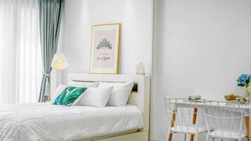 A neatly arranged bedroom with a bed, a bedside table, and a chair.