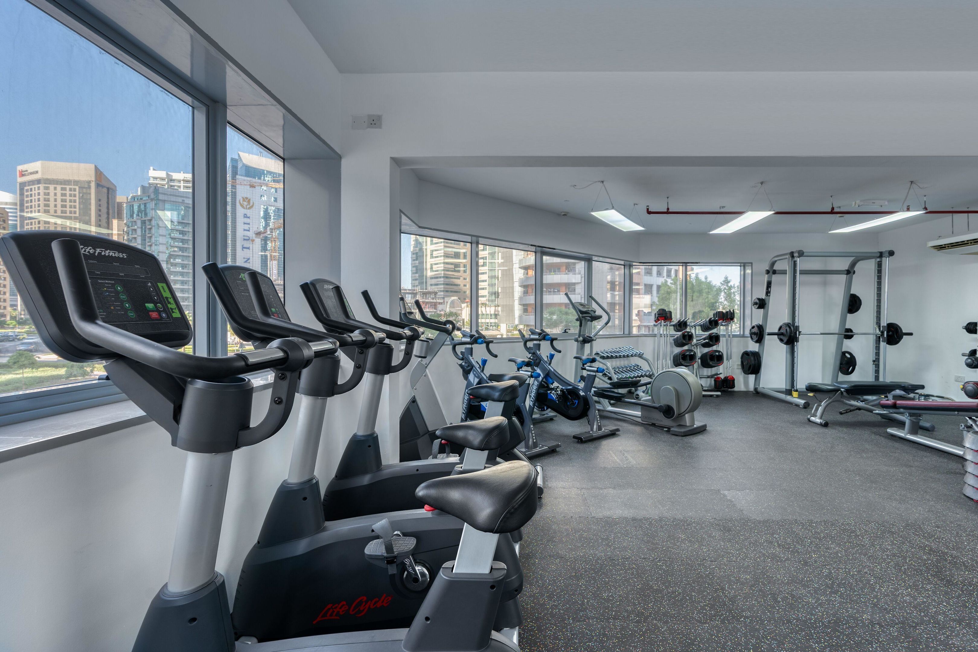 A gym with stationary bikes, treadmills, and weightlifting equipment.