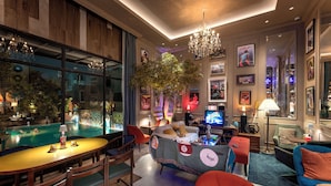 A modern living room with a pool, comfortable seating, and a television.