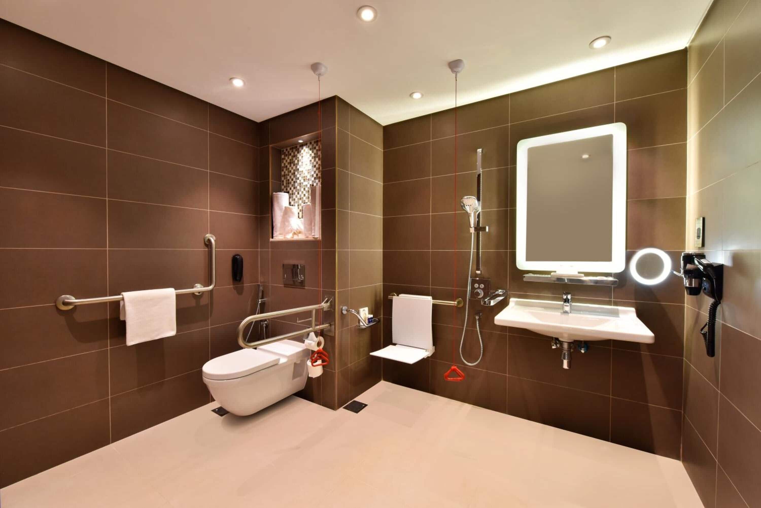 A modern bathroom with a toilet, sink, and shower.