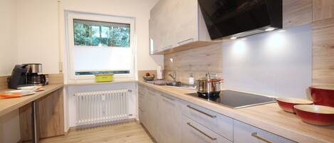 Fridge, stovetop, dishwasher, coffee/tea maker