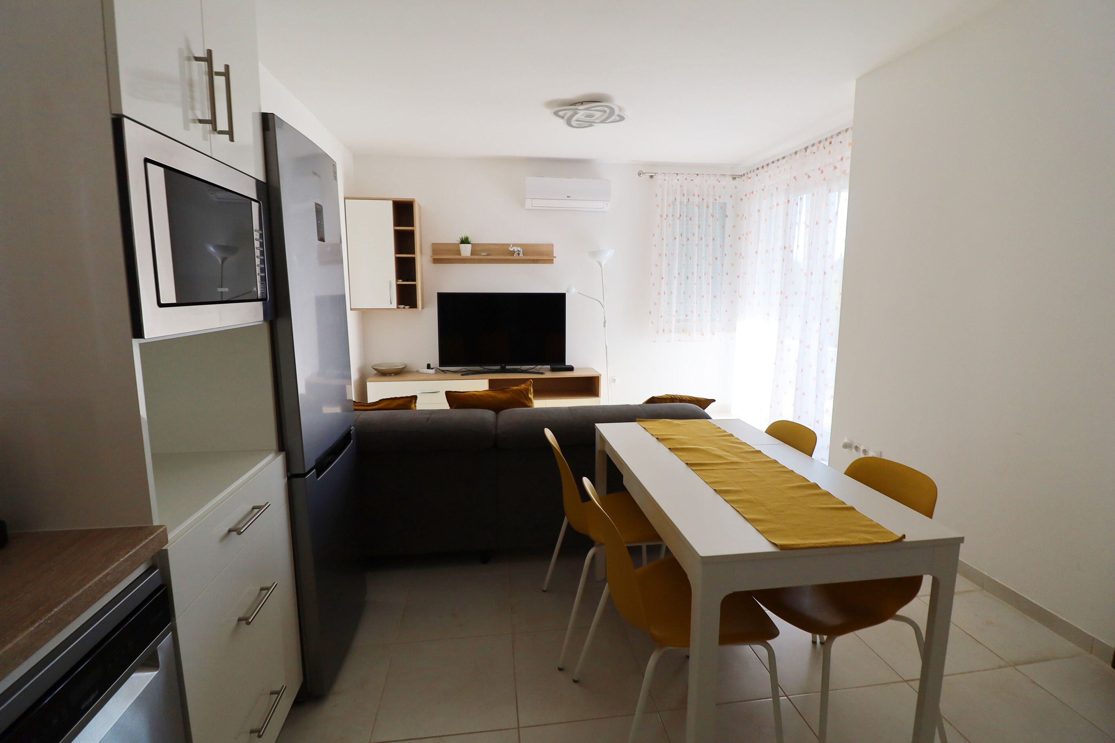 A compact living space with a kitchenette, a dining area, and a seating area.