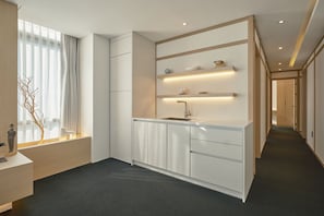 Una cocina moderna con un lavamanos integrado, armarios blancos y una encimera.