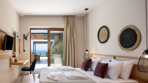 A modern hotel room with a bed, a desk, a chair, and a TV.