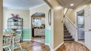 A kitchen with a dining area, a staircase, and a laundry room. - Ober Hideaway, Hot Tub, WIFI, $560 FREE tickets each paid day!!! (Gatlinburg)