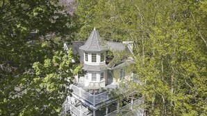 A multi-story house with a tower, surrounded by dense trees. - Ober Hideaway, Hot Tub, WIFI, $560 FREE tickets each paid day!!! (Gatlinburg)