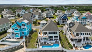 A coastal residential area with houses featuring balconies and a swimming pool. - Why Knot 4 bedroom in The Currituck Club (Corolla)