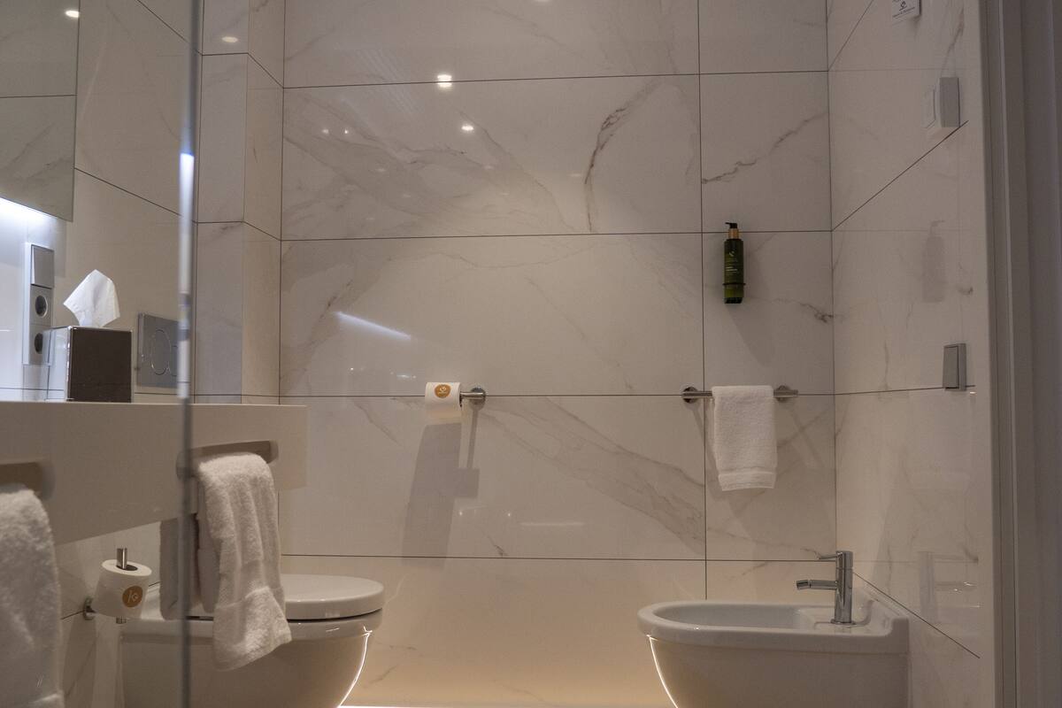 family room | bathroom | rainfall showerhead, hair dryer, heated floors, towels