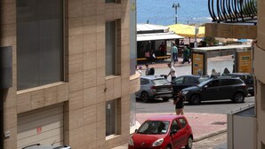 A multi-story building with balconies, a street view, and a body of water in the background. - Large 3bedroom apartment near rocky beach MCRE1-1 (Sliema)