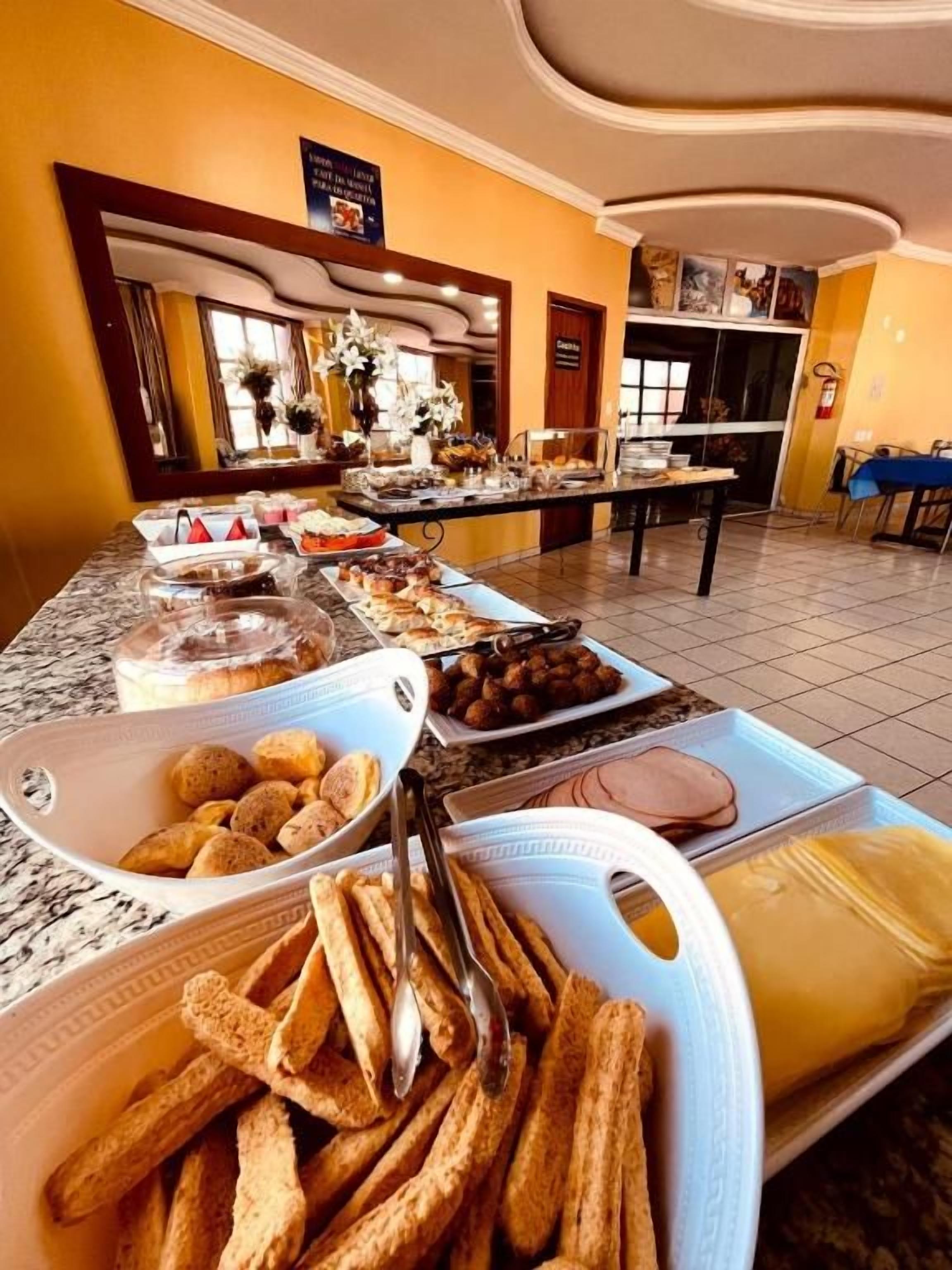A buffet setup with various food items and a seating area.