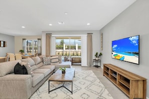 A modern living room with a sofa, coffee table, and TV.