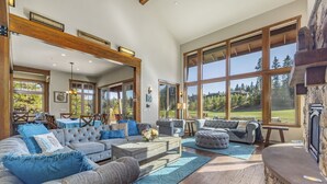 A spacious living room with a large sectional sofa, a coffee table, and a stone fireplace. - Built for Time Together! Suncadia At It's Best | Greenside Spa + GameRm (Cle Elum)