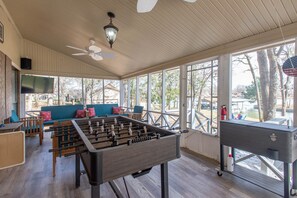 Relax in our spacious indoor recreational area, featuring a foosball table and comfortable seating.