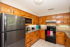 Enjoy cooking in this fully equipped kitchen with a microwave, coffee maker, and stove.