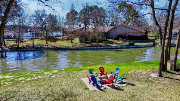 Enjoy a serene lakeside retreat with a dock for water activities and a grassy area for relaxation.