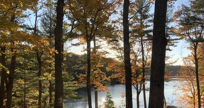 Cottage has beach with a dock