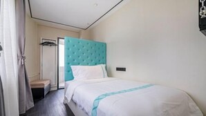A hotel room with a bed, a headboard, a bedside table, a wardrobe, and a door. - Xana Hotelle Beijing Qianmen Tianqiao Subway Station (Beijing)
