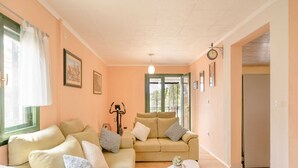 A cozy living room with two sofas, a small coffee table, and a window with curtains. - Holiday Home Melanie (Blato)