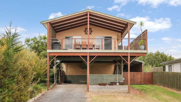 A two-story house with a covered balcony and a garage. - Settlement Sands Cowes (Cowes)