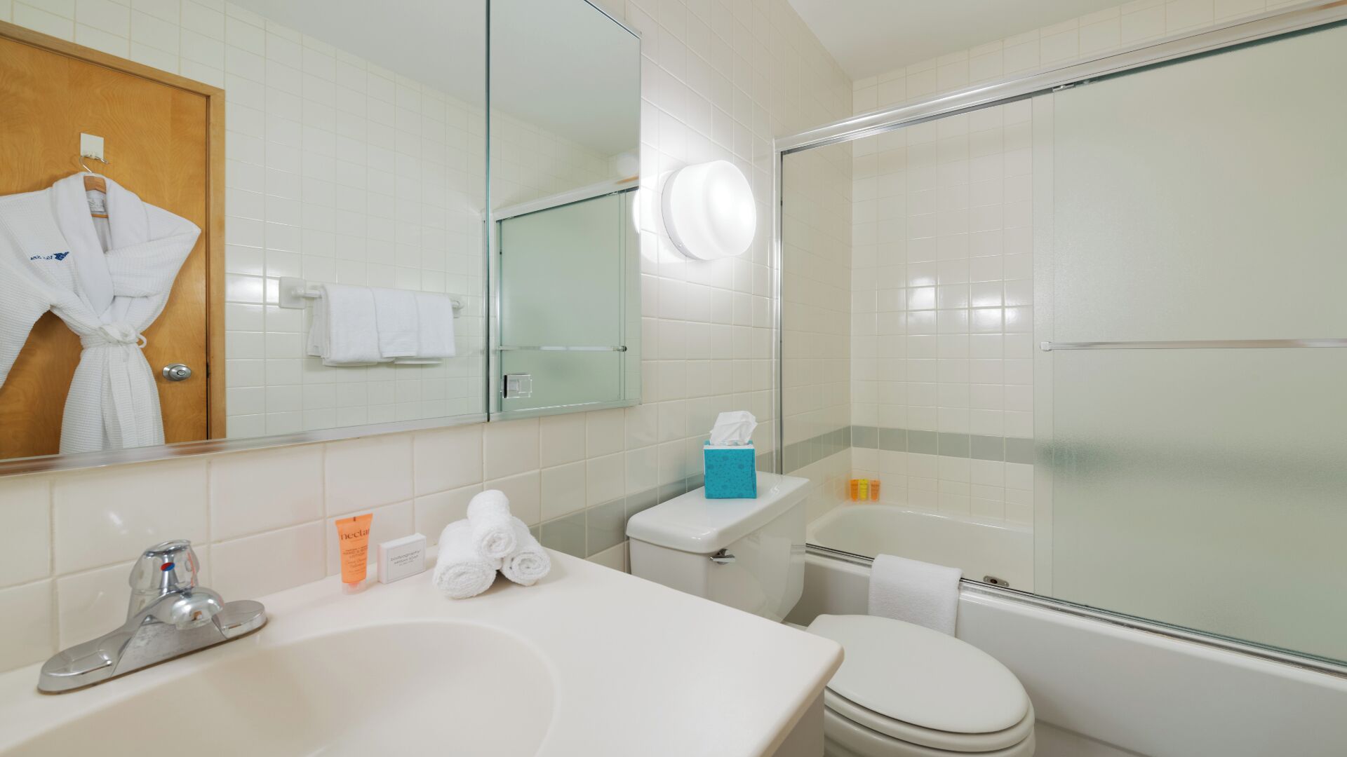 A bathroom with a sink, toilet, and shower.