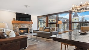 TV, fireplace, books - Serene 3BR • Stone Fireplace • Gourmet Kitchen & Vail Mountain Views (Vail)