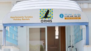 A building with a sign for 'Apartments Turistiques Holiday Rentals' and the name 'ORNIS'. - ORNIS "Becassina": 1 bedroom+sofa-bed 2/4 pers windows sea view (Sant Carles De La Rapita)