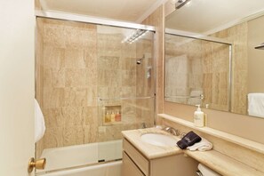 A bathroom with a glass-enclosed shower, a sink with a towel, and a mirror. - Fasching Haus by iTrip Aspen Snowmass (Aspen)