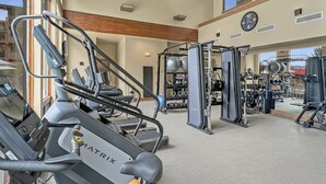 A gym with treadmills, weight machines, and free weights.