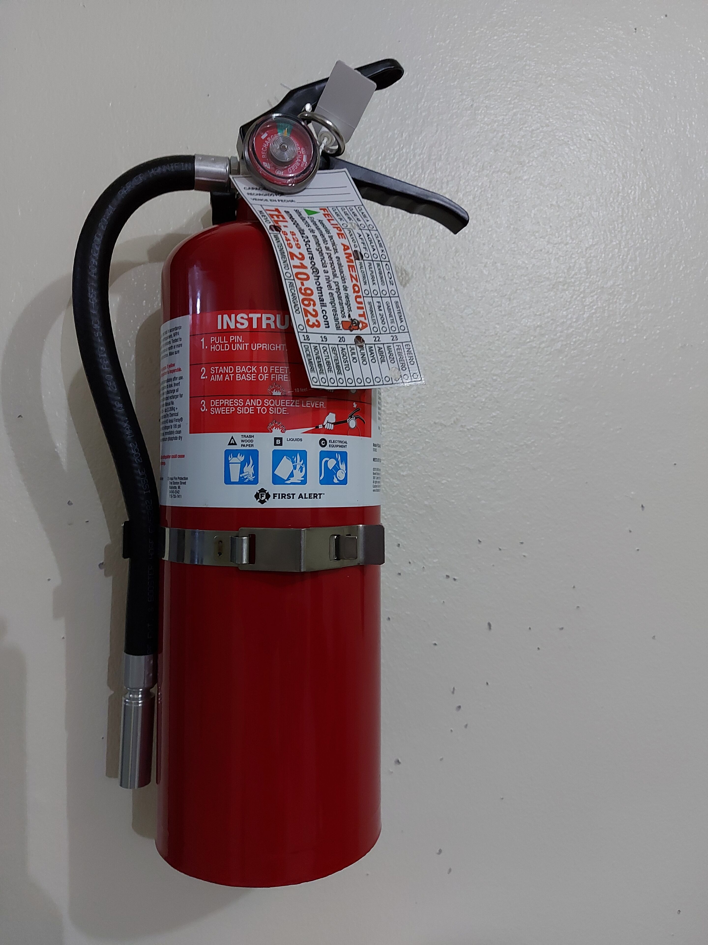 A red fire extinguisher mounted on a wall.