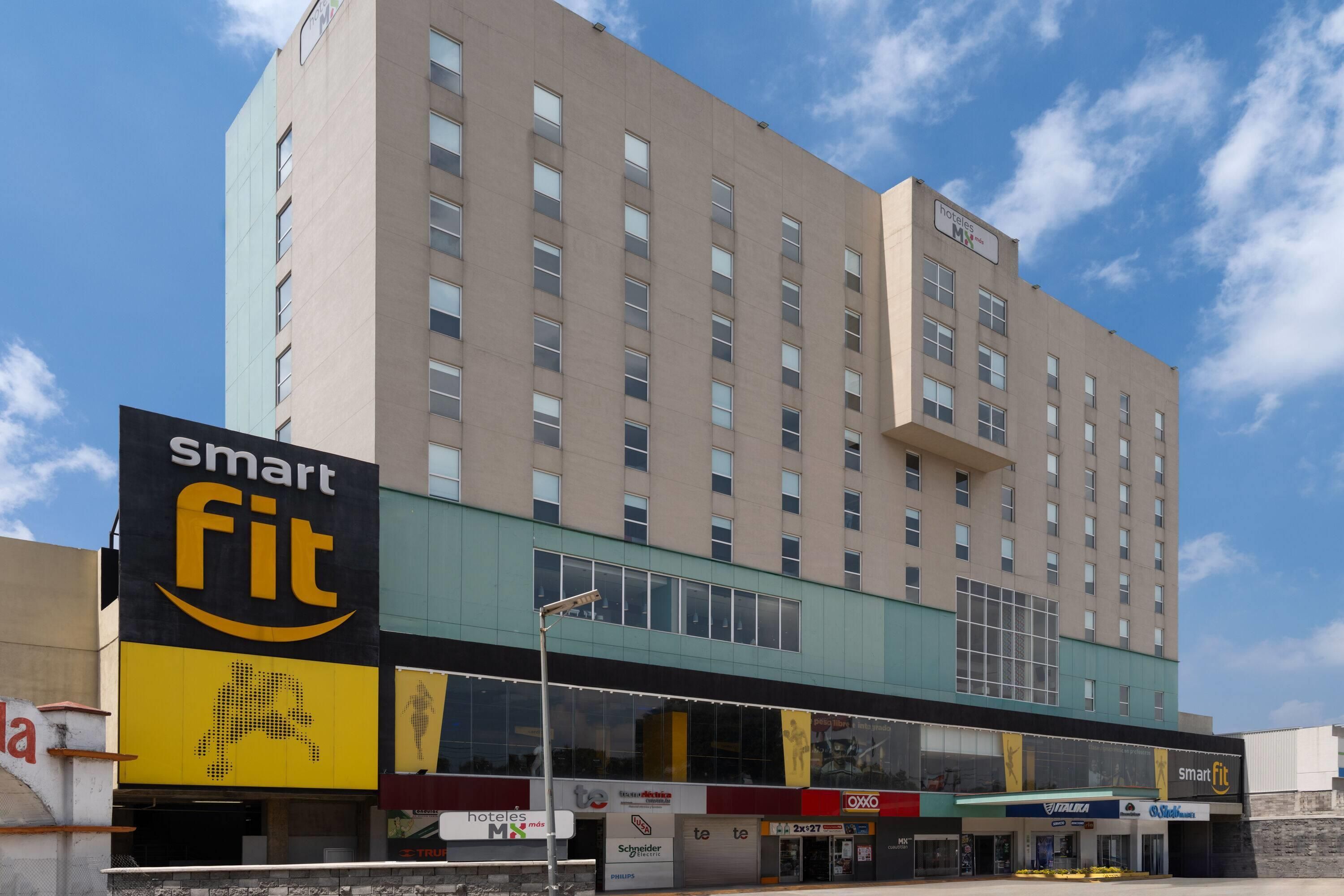 A multi-story hotel with a prominent 'smart fit' sign on the ground floor.
