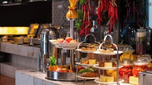 A buffet setup with various food items and condiments, including fruits, cheeses, and bread. - Beijing Minyoun Lia! by Minyoun Hotel (Wangfujing Commercial Street Dongdan Subway Station) (Beijing)