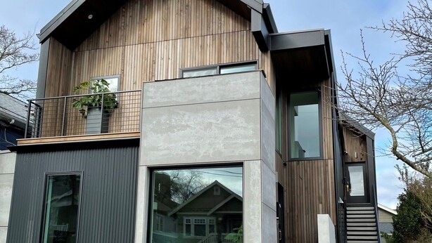 A modern two-story house with a wooden facade, large windows, and a concrete entrance. - Greenwood Getaway - Modern and New, Walk to Shops (Seattle)