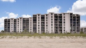A multi-story residential building with a uniform facade, balconies, and a flat roof. - Penthouse Ocean Front Resort  (Wrightsville Beach)