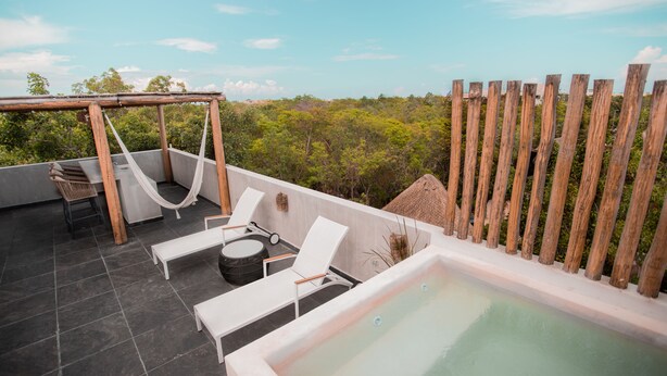 A rooftop terrace with a hot tub, lounge chairs, and a hammock. - Macondo Tulum  (Tulum)