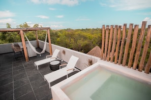 A rooftop terrace with a hot tub, lounge chairs, and a hammock. - Macondo Tulum  (Tulum)